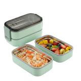 Green double-layer stainless steel lunch container set, opened to display the food trays and capacity.