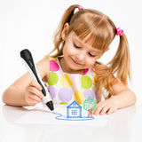 Happy young girl using a 3D drawing pen to draw a 3D house and tree on paper — kid-friendly 3D printing pen for creative play