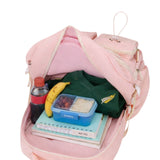 Pink school bag interior showing books, lunch box and school items